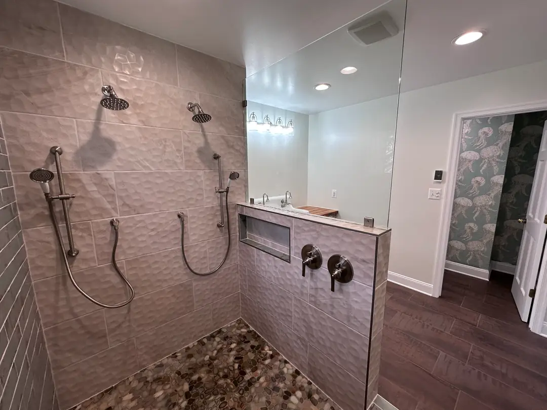 Custom tiled walk-in shower with pebble floor, built by Escobar Home Remodeling